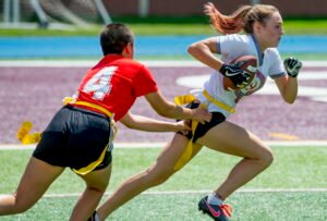 Young athletes playing competitive flag football