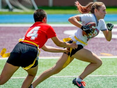 Young athletes playing competitive flag football