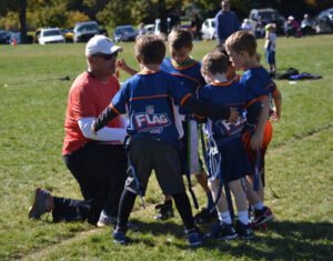 Coach speaking to his team for flag football