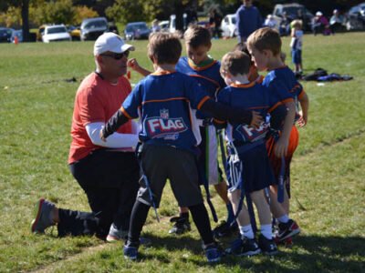 Coach speaking to his team for flag football